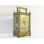 A Victorian brass carriage alarm clock with key.