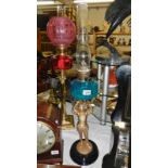 A Victorian spelter figure oil lamp with blue glass font