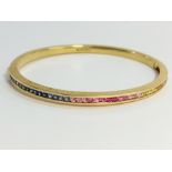 A gold bracelet set white, blue and pink stones, marked 750 (18ct).