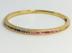 A gold bracelet set white, blue and pink stones, marked 750 (18ct).