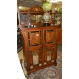 An Edwardian inlaid cabinet with bevelled mirror panels