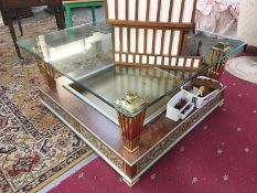 A large ormolu coffee table with glass top and recessed base.