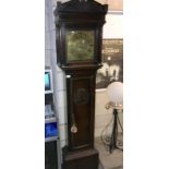 A Georgian 8 day oak long case clock with brass face and carved lady portrait on door. By W.