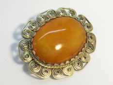 A butterscotch amber large cabachon brooch, cabachon measures 44 x 35 mm. weight 20.55 grams.