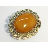 A butterscotch amber large cabachon brooch, cabachon measures 44 x 35 mm. weight 20.55 grams.