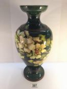 A large Doulton Lambeth Faience vase by Mary Butterton with sprigs of pink blosson and light green