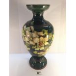 A large Doulton Lambeth Faience vase by Mary Butterton with sprigs of pink blosson and light green