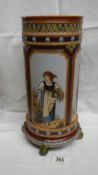 A tall heavy Mettlach spill type vase on 4 green feet with 4 panels each depicting a woman in the