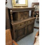 A carved oak court cupboard.