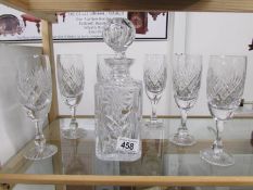 A cut glass decanter and a set of 6 glasses.