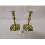 A pair of 19th century brass petal based candlesticks.
