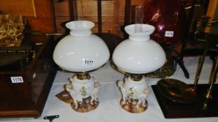 A pair of Sitzendorf porcelain oil lamps.