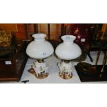 A pair of Sitzendorf porcelain oil lamps.