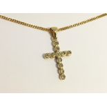 A gold and diamond cross on chain.