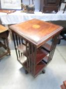 A mahogany inlaid revolving book case.