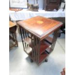 A mahogany inlaid revolving book case.