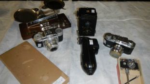 An Eastman chemical scales, a photo lite camera lighter, a Voigtlander camera,