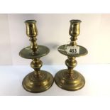 A pair of 19th century heavy brass candlesticks with drip trays.