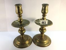 A pair of 19th century heavy brass candlesticks with drip trays.