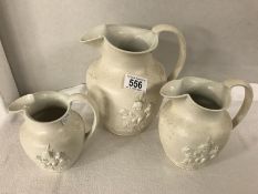 A set of 3 graduated Wedgwood creamware jugs embossed with cherubs and foliage.