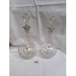 A pair of small Mary Gregory glass decanters.