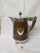 A 19th century oak and silver plate jug with ceramic lining.