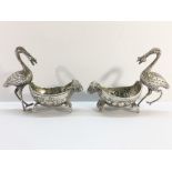 A pair of continental silver salts surmounted storks, marked 800.