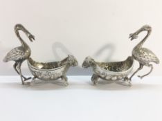 A pair of continental silver salts surmounted storks, marked 800.