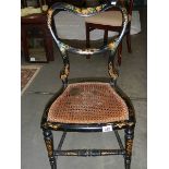 A 19th century lacquered chair with cane seat.