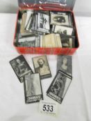A tin of in excess of 300 Ogden's early photographic cigarette cards.