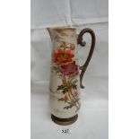 A Doulton early Pinder Bourne & Co. tall thin jug with anemone type flowers on opposite sides.