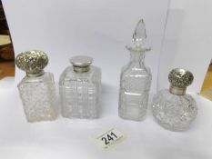 3 silver topped scent bottles and one other.