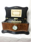 A superb quality walnut cased Victorian music box playing 8 aires & with inset clock