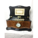 A superb quality walnut cased Victorian music box playing 8 aires & with inset clock