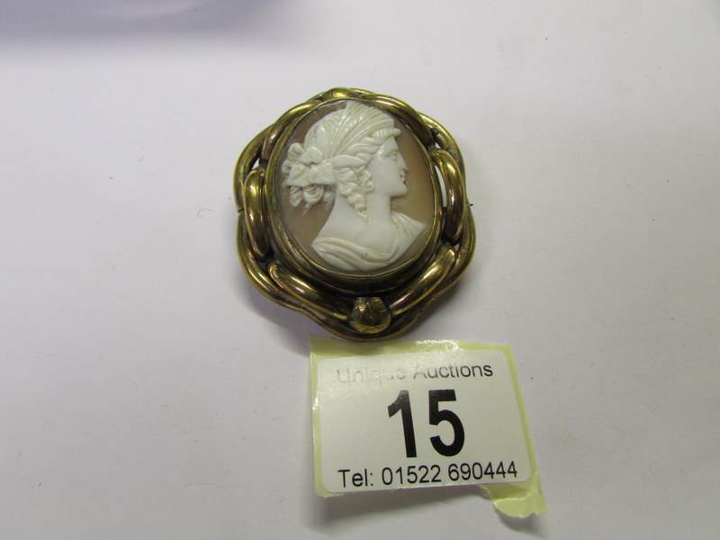 A Victorian yellow metal memorial brooch with shell cameo of female profile (missing glass from