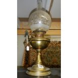 A brass oil lamp with shade & chimney