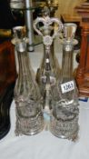 A 3 bottle silver plated tantalus,