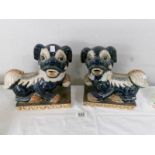 A pair of pottery dogs of fo.