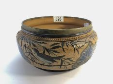A Doulton Lambeth 1881 shallow bowl with 4 birds with branches, leaves and stylised flowers.