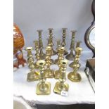 7 pairs of Victorian brass candlesticks.