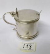 A silver mustard pot with blue glass liner and complete with spoon, T B & S, 1917.