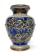 An 1875/76 Doulton Lambeth rounded vase by Emma Martin having a blue pattern on a brown ground with