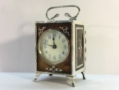 A silver and tortoise shell carriage clock (fine crack to tortoise shell front).