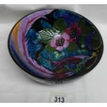 A bowl depicting a very colourful peacock.
