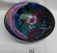 A bowl depicting a very colourful peacock.