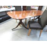 A double pedestal oval mahogany dining table with string inlay.