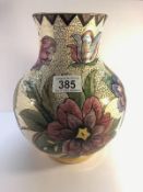 A Moorcroft bulbous vase hand painted by Irving featuring large stylised flowers on a white base