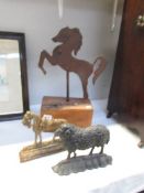 A cast iron ram doorstop, a cast iron horse door stop and another metal horse on base.