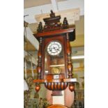 A small mahogany wall clock