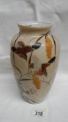 A Chinese/Oriental vase depicting birds, flowers and grasses. Approximate height 24cm/ 9 1/2".